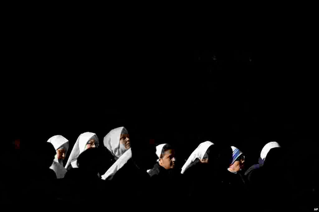 Nuns attend a mass celebrated by Pope Francis in St. Peter's Basilica, at the Vatican, to mark Epiphany. The Epiphany day is a joyous day for Catholics in which they recall the journey of the Three Kings, or Magi, to pay homage to baby Jesus.