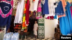 Tunisian shopkeeper Aghmi Bubaker speaks with Reuters journalists at his shop in Sousse, Tunisia, June 30, 2015. 