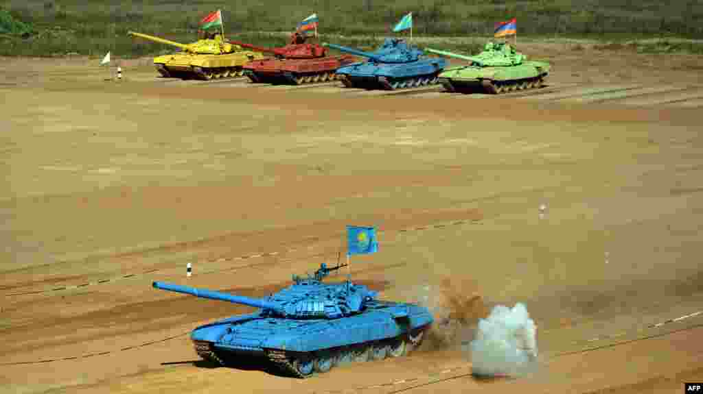 Tanks of (back L-R) Belarus, Russian, Kazakh and Armenian teams line up as they compete during ‘tank biathlon’, a new paramilitary sport about armor races and precision gunnery near Alabino, outside Moscow, Russia.