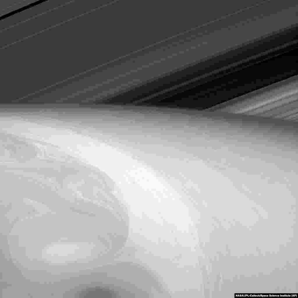 This Aug. 23, 2014 image made available by NASA shows the fluid dynamics in Saturn's uppermost cloud layers.