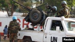 FILE - U.N. peacekeepers take a break as they patrol along a street during the presidential election in Bangui, the capital of Central African Republic, Dec. 30, 2015. 