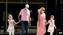 Pedestrians wear masks as they cross Brand Boulevard, July 23, 2020, in Glendale, Calif.