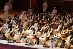Members of the Taliban delegation attend the opening session of peace talks between the Afghan government and the Taliban, in Doha, Qatar, Sept. 12, 2020.