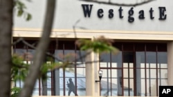 A Kenyan soldier runs through a corridor on an upper floor, shortly before an explosion was heard, at the Westgate Mall in Nairobi, Sept. 24, 2013. 