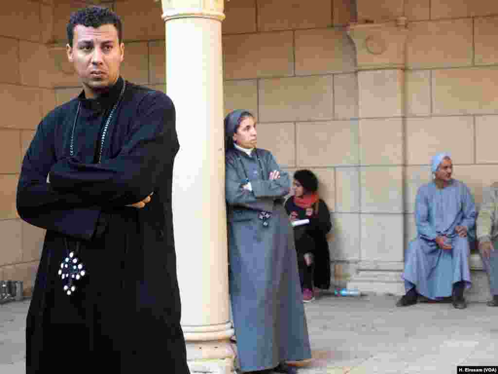 Priests, nuns and some of copts, who were attending the mass, are looking inside the “Botrosia” church in the cathedral complex following the blast in Abbasssya in Cairo, Dec. 11, 2016.