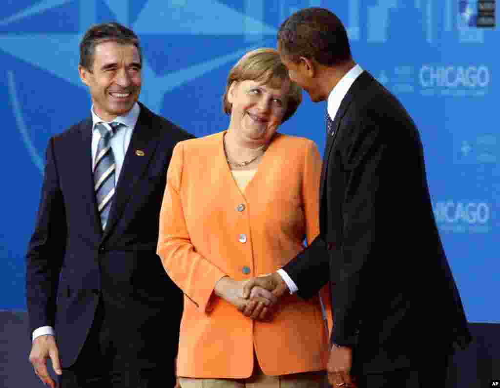German Chancellor Angela Merkel talks to President Obama at the Summit. At left is NATO Secretary General Anders Fogh Rasmussen.