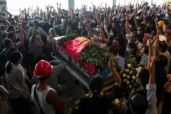 People attend the funeral of a demonstrator shot dead during anti-coup protests, in Yangon, Myanmar, March 5, 2021.