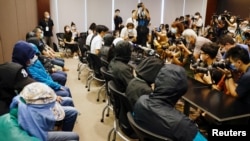 FILE - Family members of twelve Hong Kong activists, detained as they reportedly sailed to Taiwan for political asylum, hold a news conference to seek help in Hong Kong, Sept. 12, 2020.