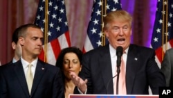 Republican presidential candidate Donald Trump speaks to supporters at his primary election night event at his Mar-a-Lago Club in Palm Beach, Fla., March 15, 2016. At left is his campaign manager Corey Lewandowski.