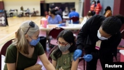 Pearl Werner, 13, receives a coronavirus disease (COVID-19) vaccine at a clinic run by the Philadelphia Department of Public Health in partnership with the Black Doctors COVID-19 Consortium to encourage all eligible teenagers to get vaccinated in Philadel