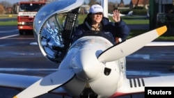 Belgian-British pilot Zara Rutherford, 19, gestures following her landing at Kortrijk-Wevelgem Airport, after a round-the-world trip in a light aircraft, in Wevelgem, Belgium, January 20, 2022. (REUTERS/Pascal Rossignol)