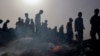 FILE - Palestinians gather at the site of an Israeli strike on a camp for internally displaced people in Rafah on May 27, 2024, amid ongoing battles between Israel and the Palestinian Hamas militant group.