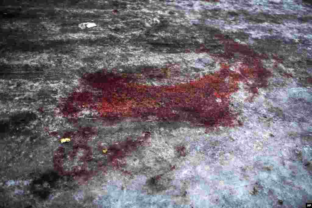 Blood from a Donetsk People's Republic soldier killed at the airport is seen at the gate of the morgue of Kalinisky Hospital, center of Donetsk, Ukraine, Jan. 18, 2015.