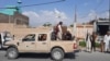 Militan Taliban mengendarai kendaraan Tentara Nasional Afghanistan (ANA) melalui jalan-jalan di Provinsi Laghman pada 15 Agustus 2021. (Foto: AFP)
