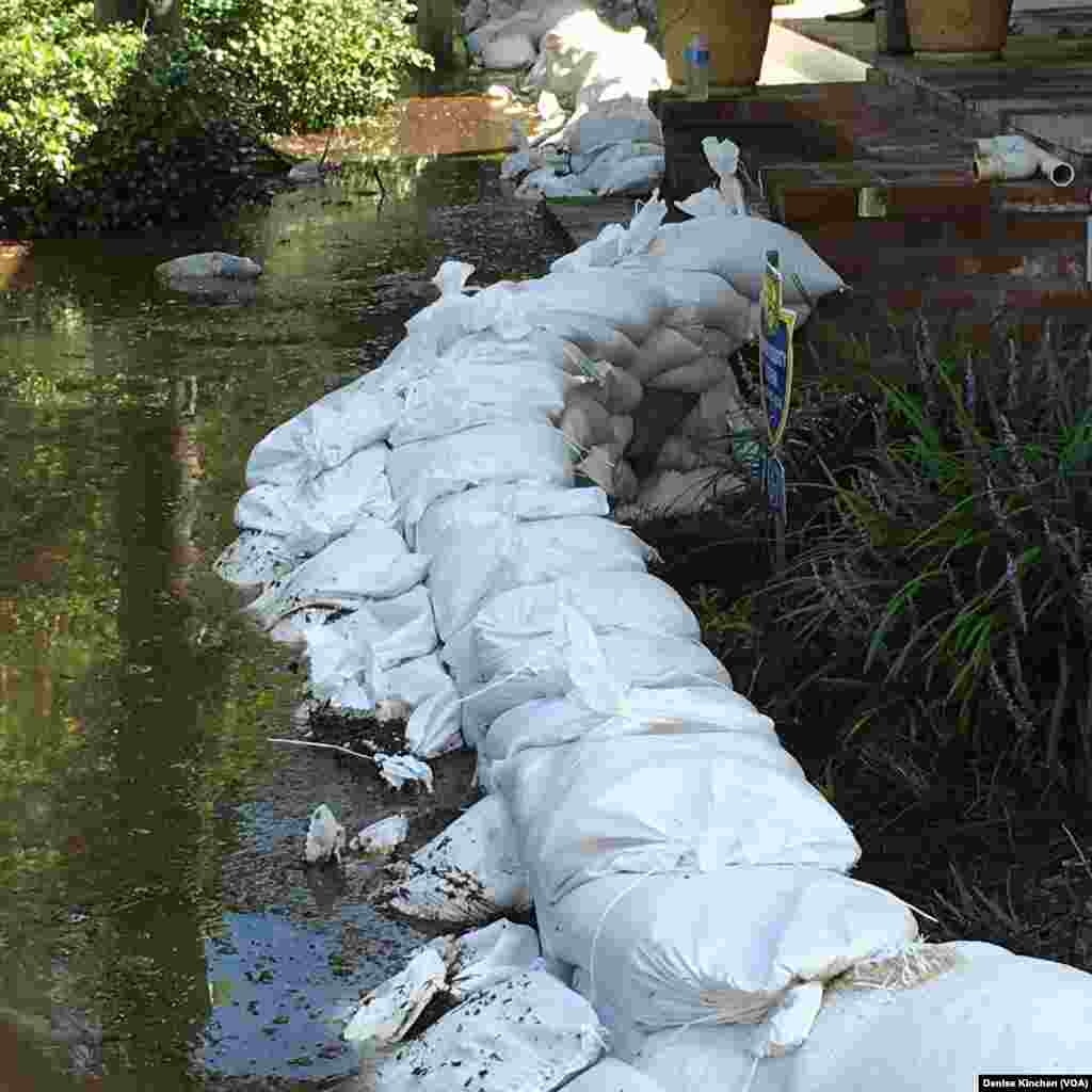 Sandbags are used to keep floodwaters away from the Kinchen family's home, in of St. Amant, La., Aug. 18, 2016.