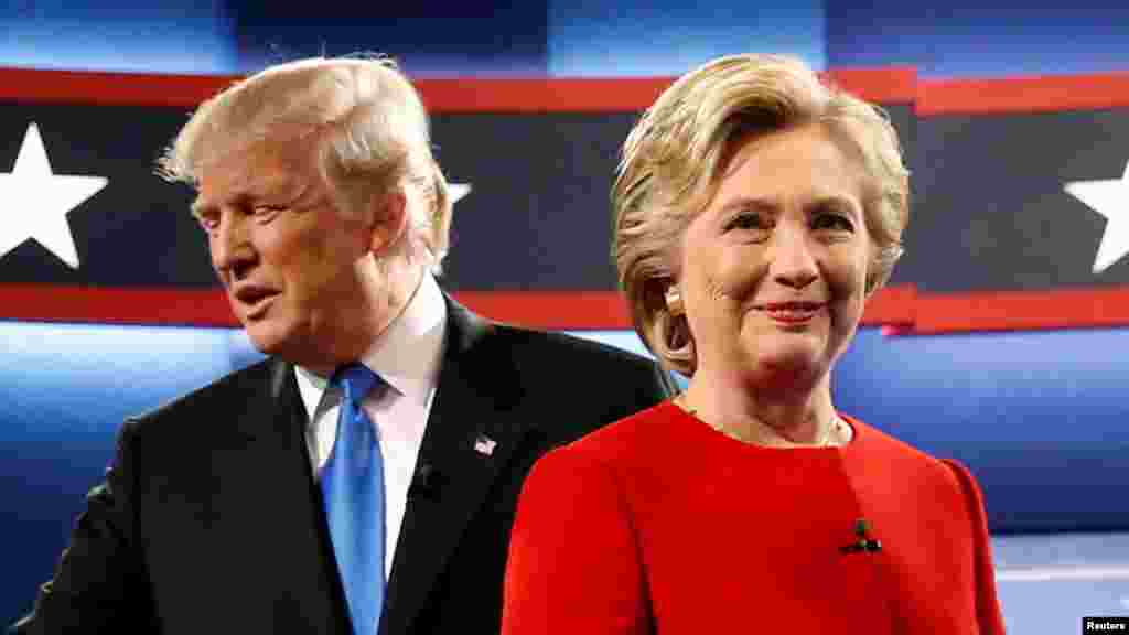Republican U.S. presidential nominee Donald Trump and Democratic U.S. presidential nominee Hillary Clinton greet one another as they take the stage for their first debate at Hofstra University in Hempstead, New York, Sept. 26, 2016.