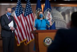 FILE - House Speaker Nancy Pelosi and Senate Minority Leader Chuck Schumer, left, meet with reporters on Capitol Hill in Washington, Nov. 12, 2020.