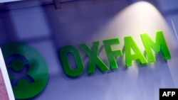 FILE - An Oxfam logo is seen on one of the organization's bookshops in Glasgow, Scotland, Feb. 10, 2018.