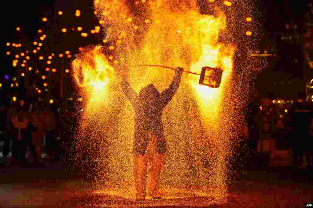 A folk performer sprays molten metal during a show in Xingyi, in China's southwest Guizhou province on Jan. 22, 2025, during the celebrations of the Lunar New Year which starts on Jan. 29.