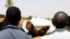 Locals and relatives of three Sudanese men riddled with bullets carry one of the bodies in the city of Omdurman across the River Nile from Khartoum, Sudan, July 1, 2019. 