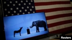 FILE - The mascots of the Democratic and Republican parties, a donkey for the Democrats and an elephant for the GOP, are seen on a video screen at a rally in Cleveland, Ohio, March 8, 2016.