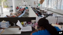 FILE - People get treatment at Haiti's first permanent cholera center, run by Gheskio Centers, in downtown Port-au-Prince, Haiti, Feb. 24, 2016.