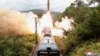 Sebuah rudal terlihat diluncurkan saat latihan Resimen Rudal Kereta Api di Korea Utara pada 16 September 2021. (Foto: KCNA via REUTERS)