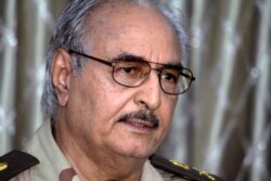 FILE - Libyan Gen. Khalifa Hifter addresses a press conference in Benghazi, Libya, May 17, 2014.