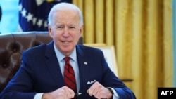 FILE - President Joe Biden prepares to sign executive orders on affordable health care in the Oval Office of the White House in Washington, Jan. 28, 2021.