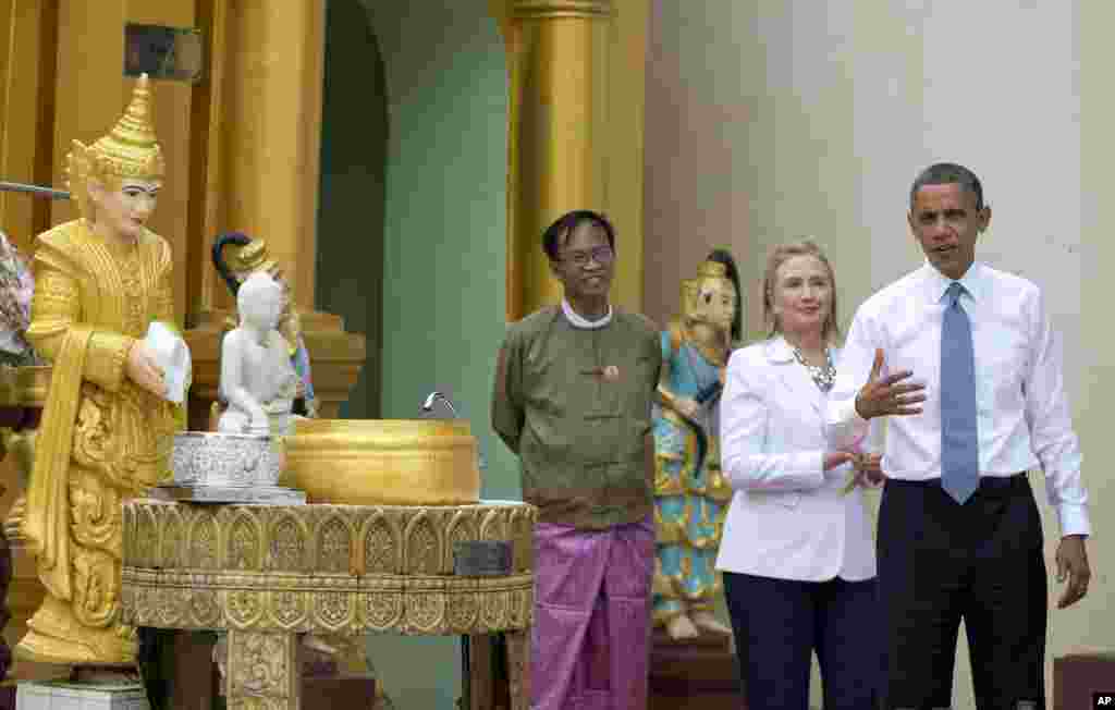 US President Barack Obama speaks to the media after he "doused eleven flames" as he tours the Shwedagon Pagoda with Secretary of State Hillary Rodham Clinton in Rangoon, Burma, November 19, 2012.