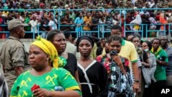 Mourners queue to pay their respects as the body of former President John Magufuli lies in state at Uhuru stadium in Dar es Salaam, Tanzania, March 20, 2021.