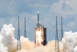 FILE - The Long March 5 Y-4 rocket, carrying an unmanned Mars probe of the Tianwen-1 mission, takes off from Wenchang Space Launch Center in Wenchang, Hainan Province, China, July 23, 2020.