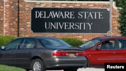 FILE - Vehicles await entry at an entrance to Delaware State University in Dover, Delaware Sept. 21, 2007. 