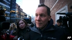 Harvard University professor Charles Lieber is surrounded by reporters as he leaves the Moakley Federal Courthouse in Boston, Jan. 30, 2020.