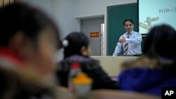 In this Dec. 1, 2009 photo, economist Ilham Tohti speaks to students at the Central Nationalities University in Beijing, China.