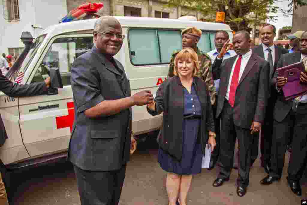 Sierra Leone's president Ernest Bai Koroma (left) is handed the keys to an ambulance by U.S. Embassy representative Kathleen FitzGibbon, one of five ambulances donated by the U.S. to help combat the Ebola virus in the city of Freetown, Sierra Leone, Sept. 10, 2014.