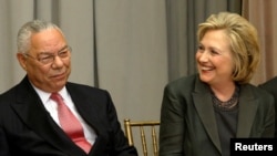FILE - Former U.S. Secretaries of State Colin Powell (L) and Hillary Clinton (R) listen to remarks at a groundbreaking ceremony for the U.S. Diplomacy Center at the State Department in Washington, Sept. 3, 2014. 