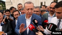 Turkish President Tayyip Erdogan talks to media after the Eid al-Fitr prayers to mark the end of the holy month of Ramadan in Istanbul, Turkey, June 4, 2019. Edogan's government has placed new rules on internet broadcasters. 