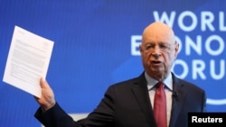 Klaus Schwab, Founder and Executive Chairman of the World Economic Forum holds the meeting's manifesto as he addresses a news conference ahead of the Davos annual meeting in Cologny near Geneva, Jan. 15, 2019.