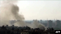 An image grab taken from a video uploaded on YouTube on July 22, 2012 shows smoke billowing from the al-Mazzeh neighborhood of Damascus, Syria.