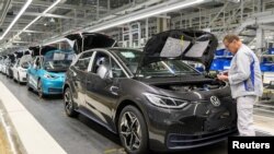 FILE - An employee works at a production line of the electric Volkswagen model ID.3 in Zwickau, Germany, Feb. 25, 2020.