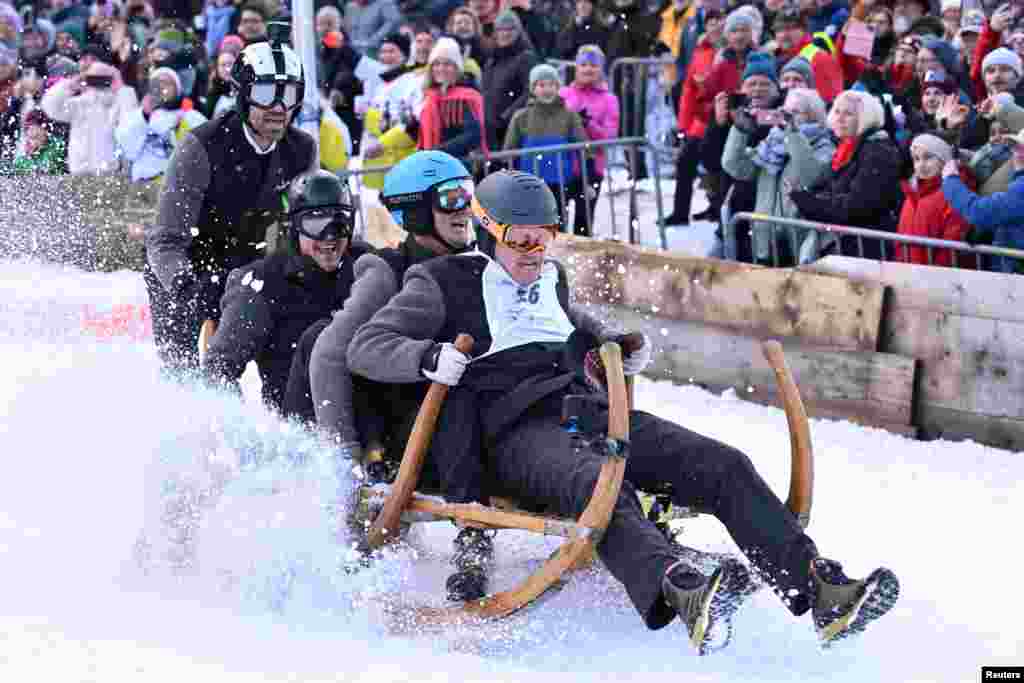 Competitors ride their wooden sledge during the traditional Bavarian horn sledge race 'Hornschlittenrennen' in Garmisch-Partenkirchen, Germany.