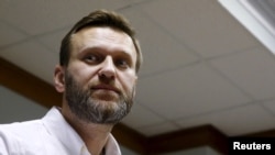 FILE - Russian anti-corruption campaigner and prominent opposition figure Alexei Navalny is seen attending a hearing at the Moscow City Court in Moscow, Feb. 12, 2016. His conviction on an embezzling charge has been overturned.