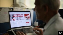 An Indian man browses through the twitter account of Alt News, a fact-checking website, in New Delhi, India, April 2, 2019. 