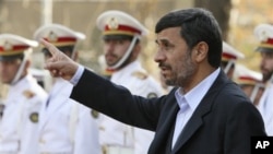 Iranian President Mahmoud Ahmadinejad gestures prior to an official welcoming ceremony for Qatari Emir Sheik Hamad Bin Khalifa Al Thani, unseen, in Tehran, Iran, 20 Dec 2010