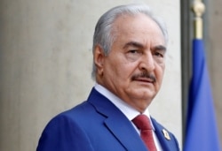 FILE - Khalifa Haftar, the military commander who dominates eastern Libya, arrives at an international conference on Libya at the Elysee Palace in Paris, May 29, 2018.