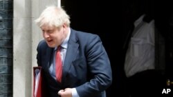 FILE - Britain's Prime Boris Johnson leaves 10 Downing Street to attend the weekly Prime Minister's Questions session in parliament, in London, July 15, 2020. 