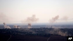 Smoke and explosions from the fighting between forces loyal to Syrian President Bashar Assad and rebels rise in the village of Jubata al-Khashab as seen from the Israeli-controlled Golan Heights, Sept. 11, 2016.