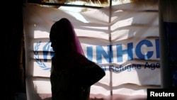 FILE - An Ethiopian refugee stands as she is registered by the United Nations High Commissioner for Refugees at the Um Rakuba camp for Ethiopian refugees fleeing the fighting in the country's Tigray region, on the Sudan-Ethiopia border, Nov. 28, 2020.