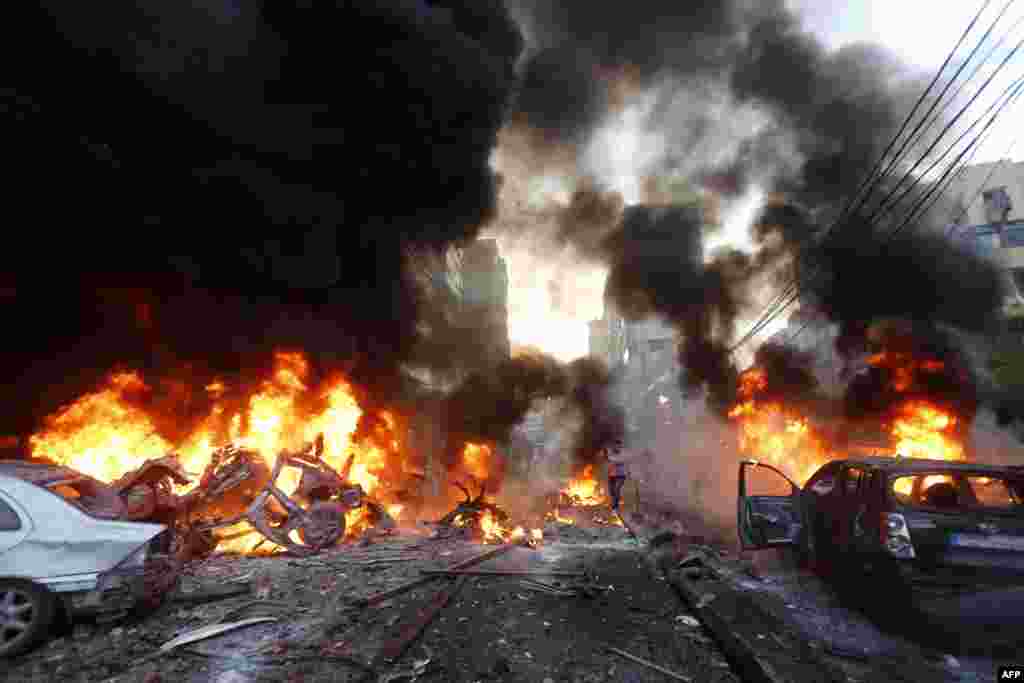 Flames rise from burning cars at the site of a car bomb that targeted Beirut's southern suburb of Haret Hreik, Lebanon. A large car bomb killed five people and wounded at least 20, a health ministry source told AFP.